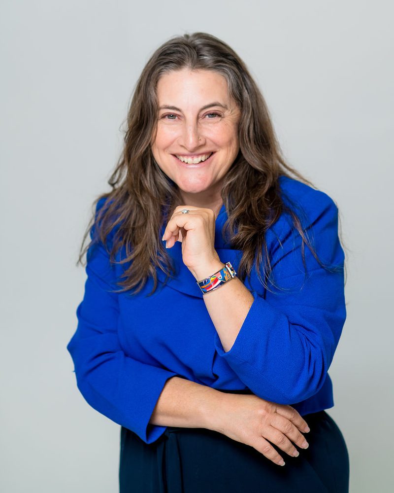 Laura Lorber, J.D., family mediator, smiling in a blue jacket